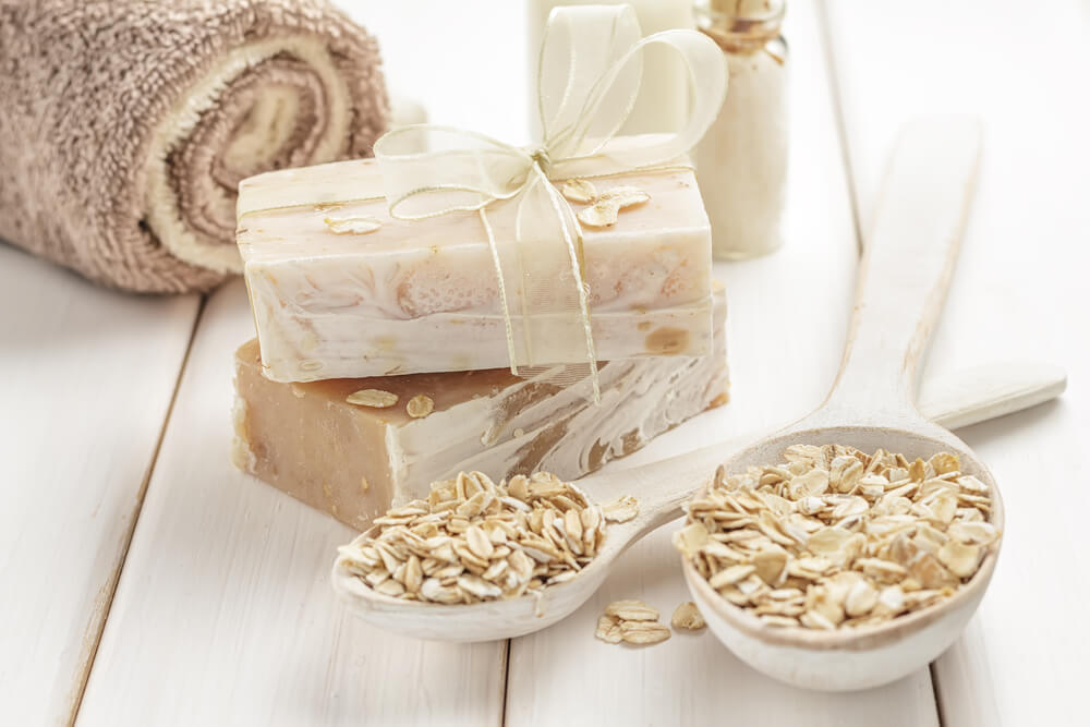 Oats in bowl with soap and towel