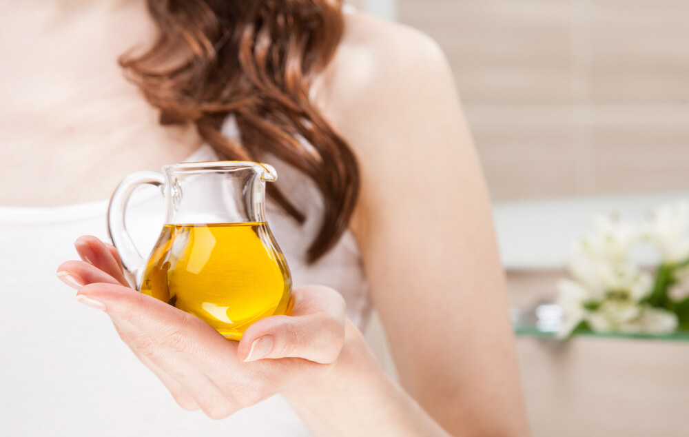 Woman holding jar of olive oil