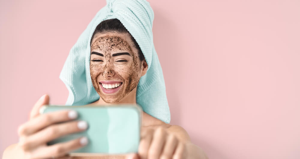 Woman taking selfie of exfoliated face