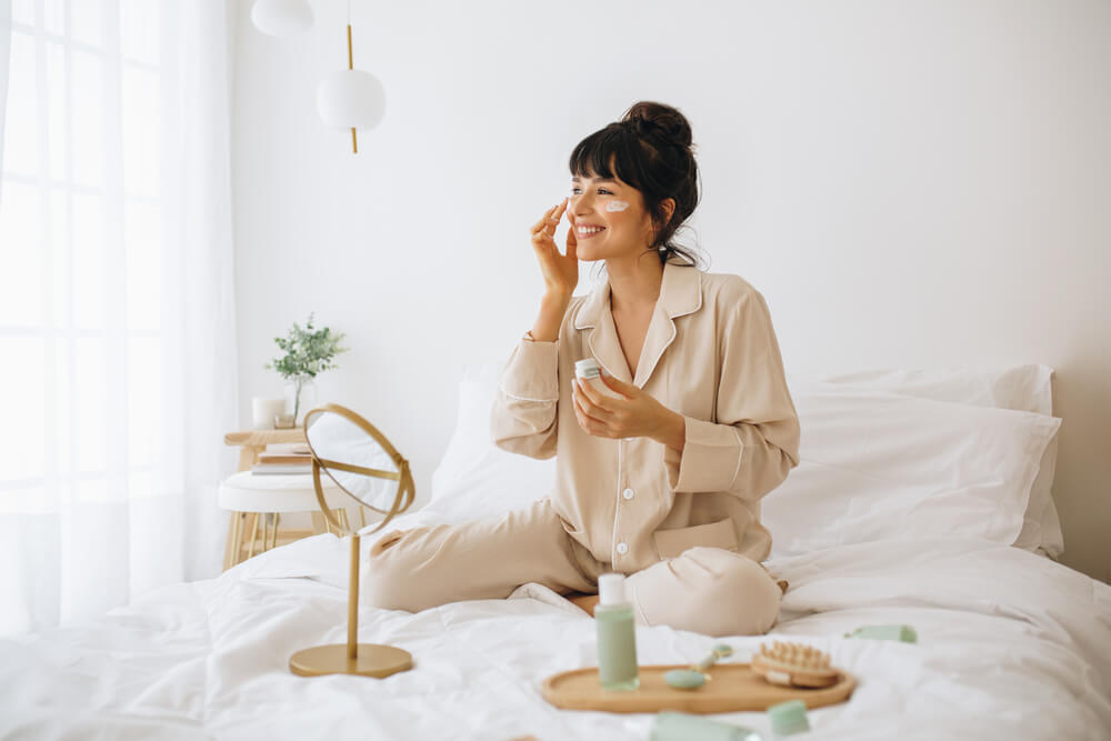 Woman applying face cream