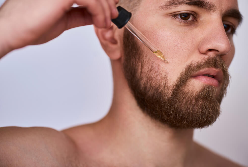 Man applying beard oil