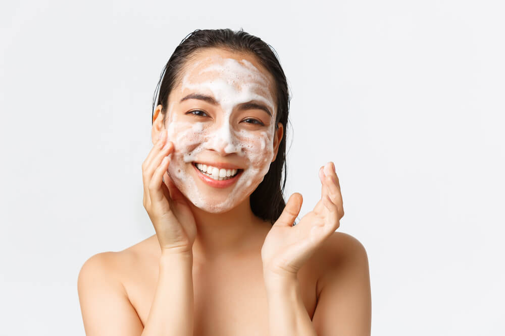 Woman cleansing skin