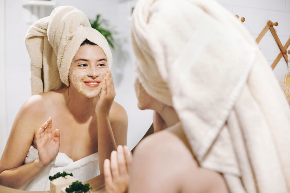 Woman applying face scrub