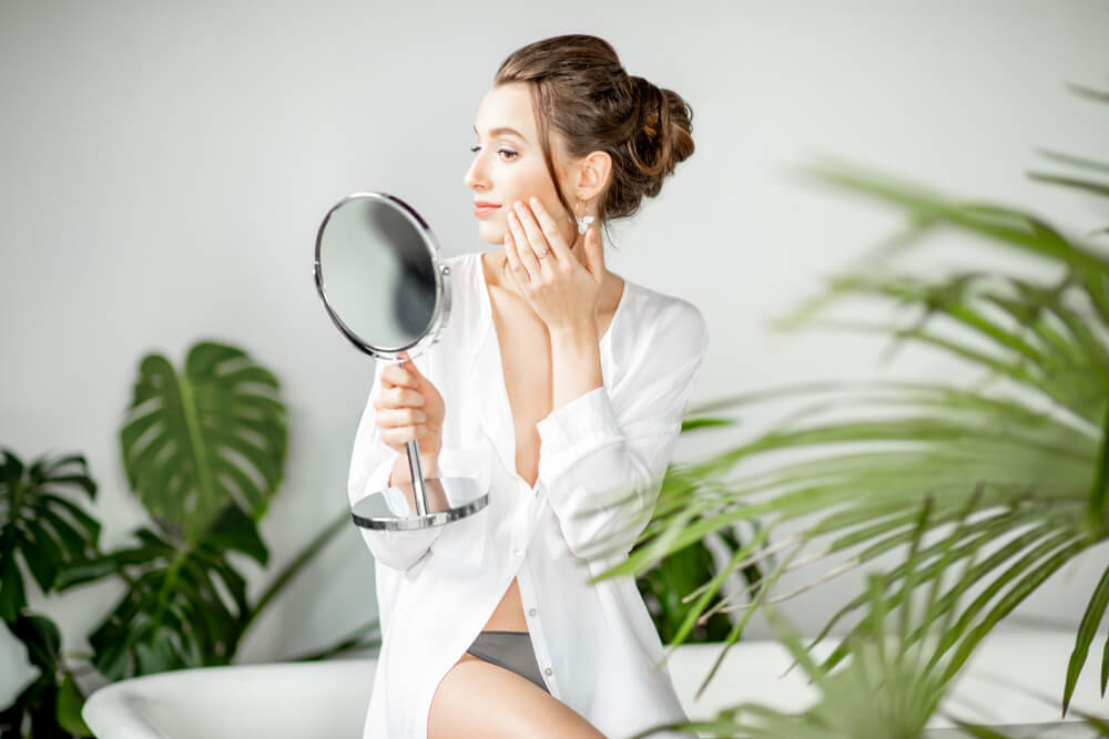 Woman touching skin after face peel