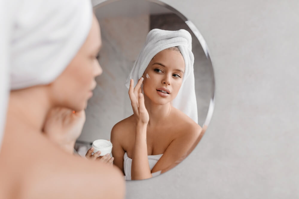 Woman applying face cream