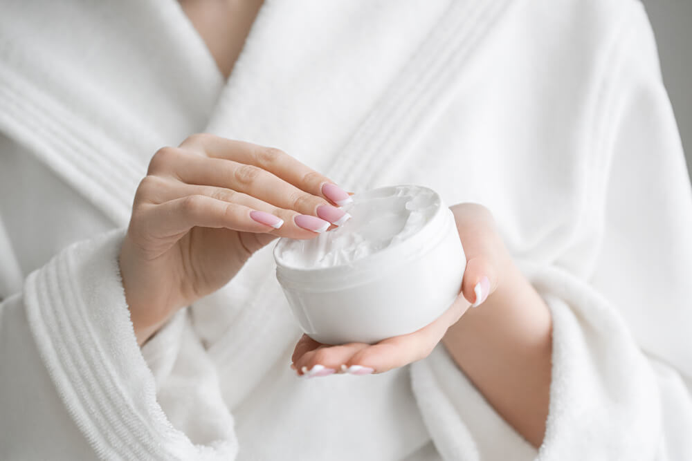 Woman using moisturizing cream