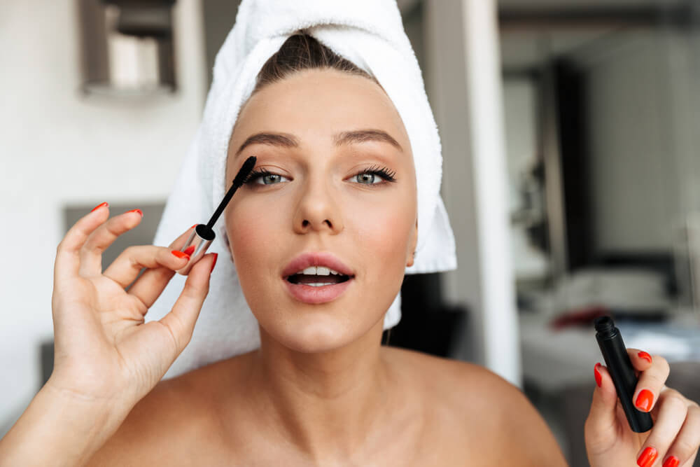 Woman applying mascara