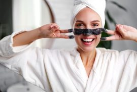 Woman applying face mask as a neuro-glow ritual