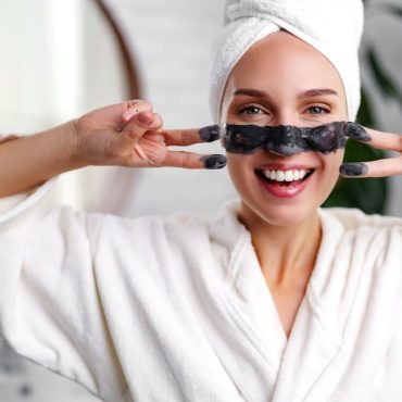 Woman applying face mask as a neuro-glow ritual