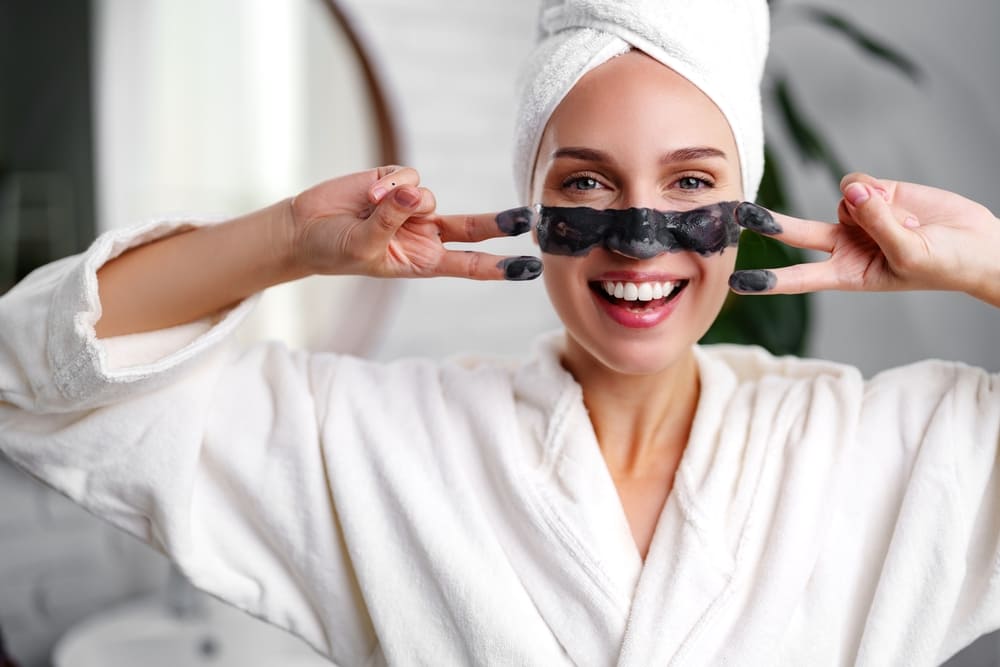 Woman applying face mask as a neuro-glow ritual