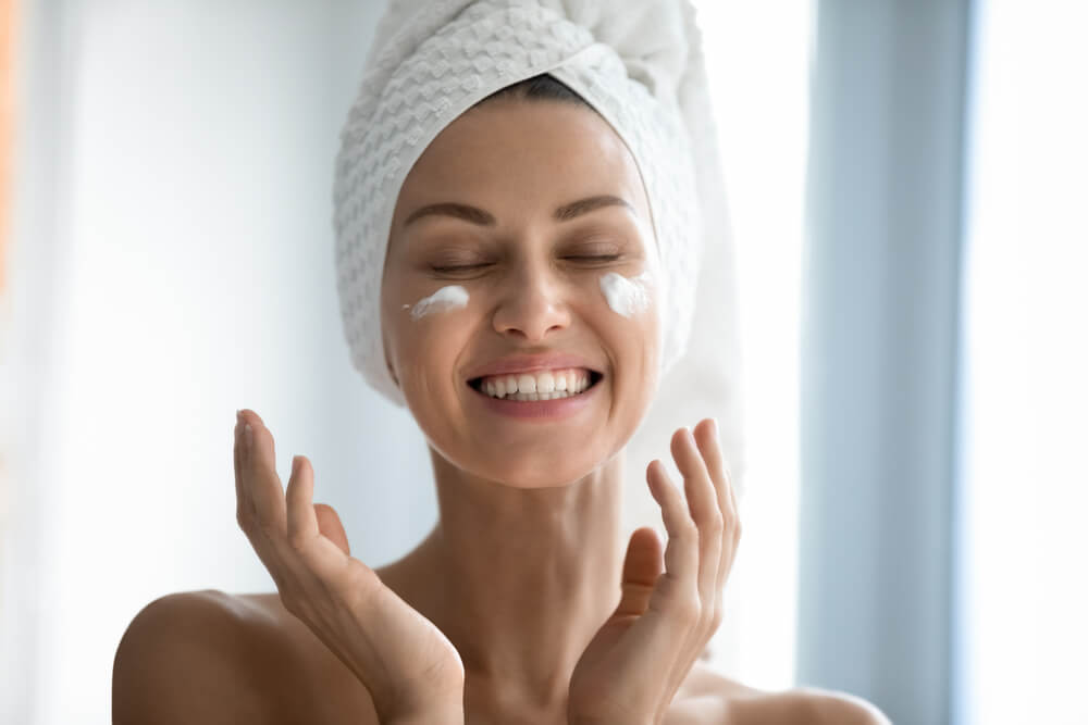 Woman applying face cream