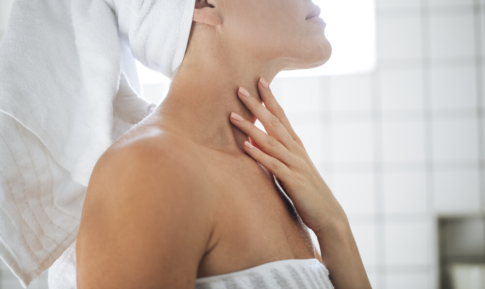 Woman applying neck serum