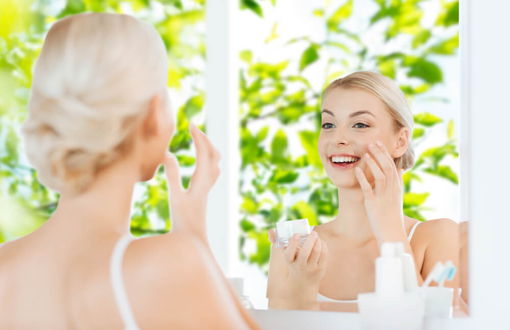 Woman applying skincare for spring