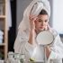 Woman looking at skin in mirror