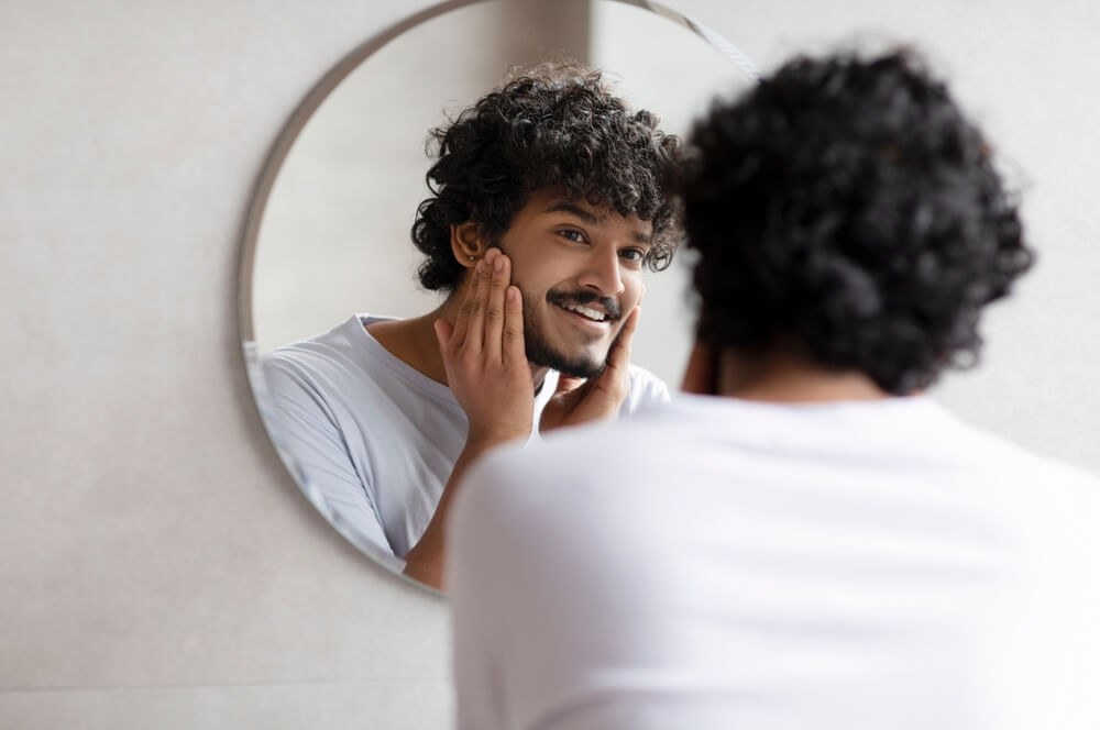 Man touching beard