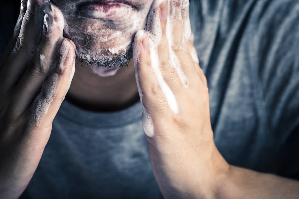 Man washing beard