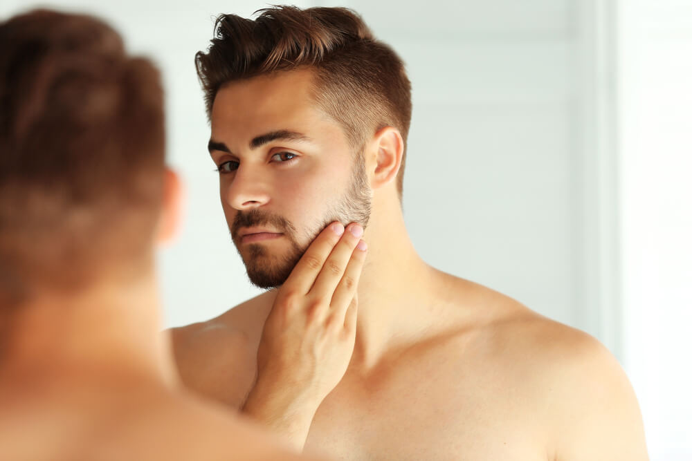 Man looking at beard