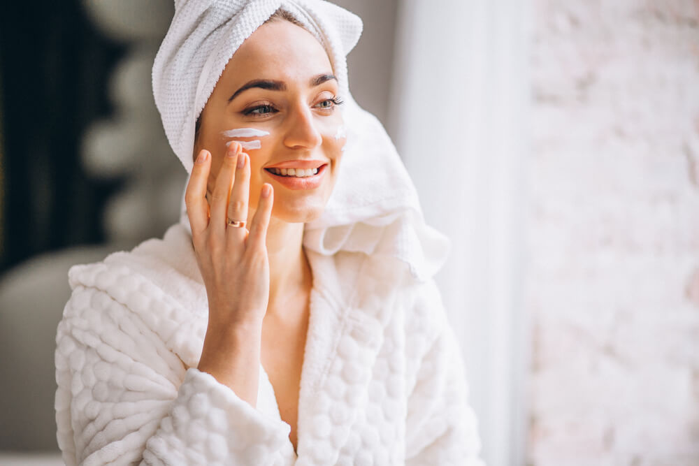 Woman applying face cream