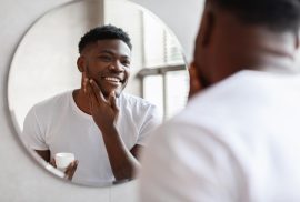 Man touching beard