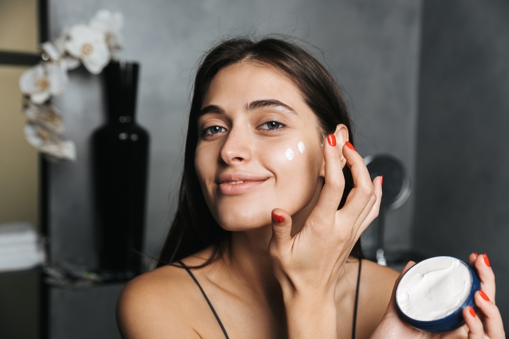 Woman applying face cream