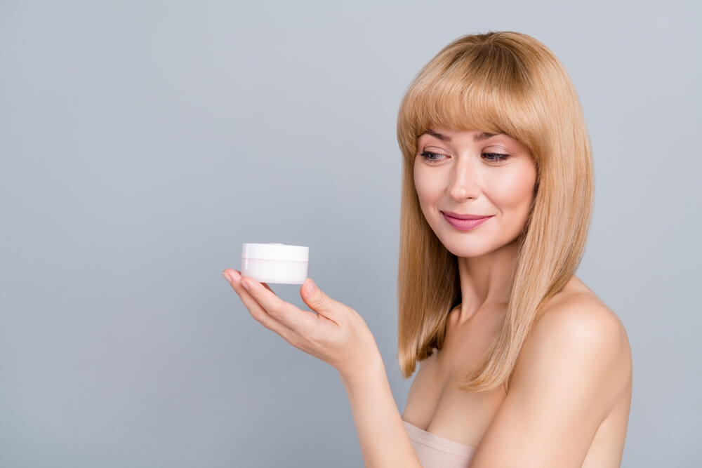 woman holding body butter