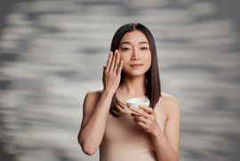 woman applying moisturizer