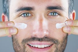 man applying skincare