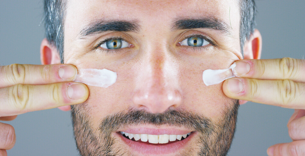 man applying skincare