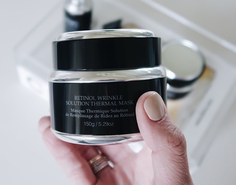 Blogger So Sage holding Retinol Wrinkle Solution Thermal Mask