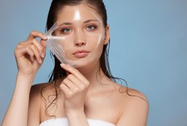 woman peeling off mask